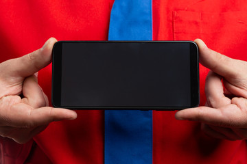 Closeup of phone screen held by hypermarket employee with copyspace.