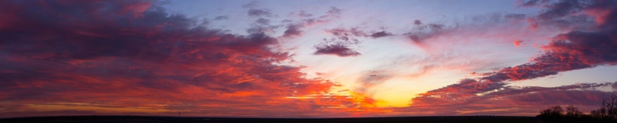 Landscape with bloody sunset. The terrain in southern Europe. Tragic gloomy sky. Purple-magenta clouds.