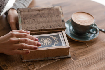 close-up of a woman's hands laying out tarot cards