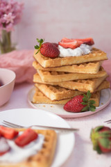 A stack of waffles with strawberries