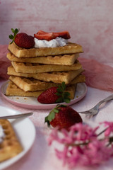 A stack of waffles with strawberries