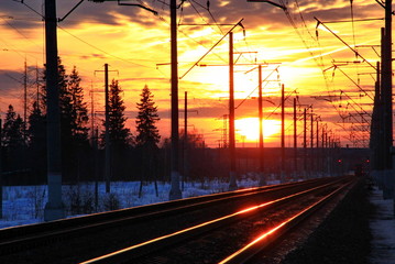 sunset, electric poles and rails
