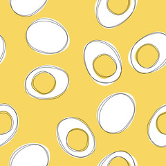 Cut boiled eggs with yolk on yellow background. Seamless pattern with eggs.