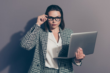 Photo portrait of serious focused confident concentrated she her office secretary holding thin notebook in hands adjusting accessories isolated grey background