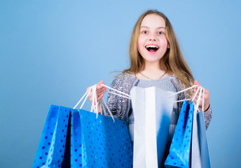 Fashion trend. Fashion shop. Little girl with bunch packages. Seasonal sale. Fashion girl customer. Happy child in shop with bags. Shopping day happiness. Birthday girl shopping. Fashion boutique