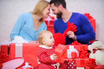 Moments of joy. Valentines day. Red boxes. Shopping. Boxing day. Love and trust in family. Bearded man and woman with little girl. father, mother and doughter child. Happy family with present box