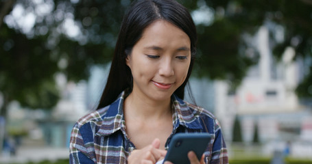 Woman look at mobile phone in city