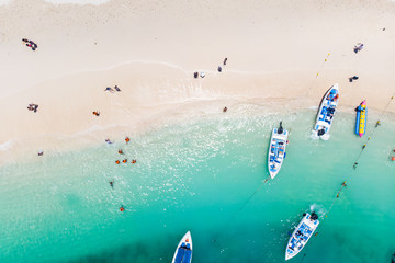 aerial shot of people and boat in waves and sand on beach in Phuket Island,Thailand