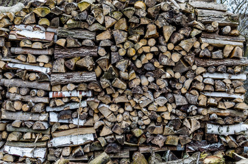 Firewood stacked on each other. Drying wood in the open air.