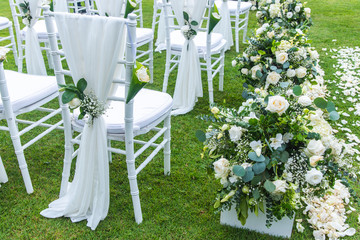 Chair decorated with flowers in Wedding ceremony.