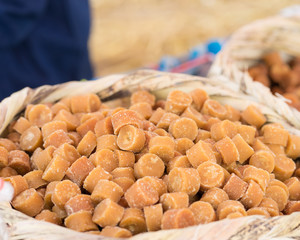 Fresh homemade molasses candies in bamboo basket,