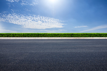 Empty asphalt road and blue sky with white clouds scene