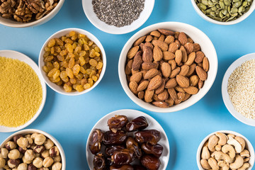Superfoods in Bowls on blue Background.