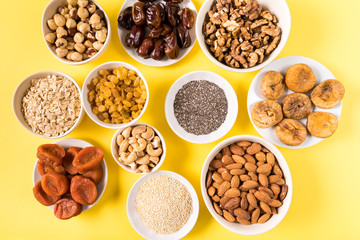 Superfoods in Bowls on yellow Background.