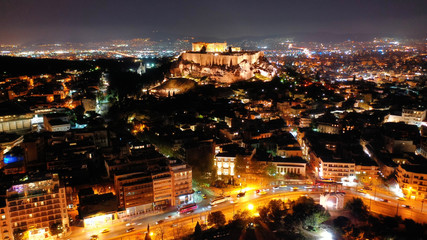 Fototapeta na wymiar Aerial drone night shot of iconic illuminated landmark Acropolis hill and the Masterpiece of Ancient times and Western civilisation - the Parthenon, Athens historic centre, Attica, Greece