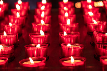 Red candles glowing in the dark. Taken in religious environment
