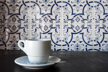 Coffee drink on wooden table over tile background