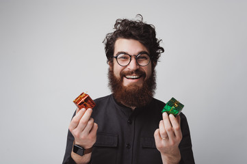 Happy bearded man holding two small gift boxes - Powered by Adobe