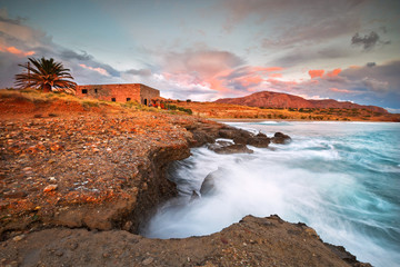 Fototapeta premium Evening view of the Diaskari beach and old store houses near the village of Makrygialos in Crete, Greece.