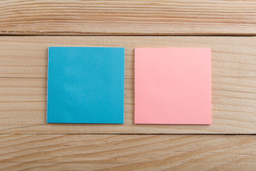 Two stickers note on wooden desk. Copy space