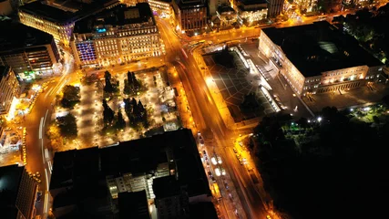 Fotobehang Aerial drone night shot from famous illuminated Syntagma square and Greek Parliament  building, Athens historic centre, Attica, Greece © aerial-drone