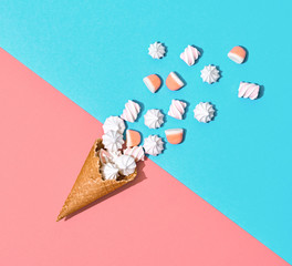Ice Cream cone with Candy Sweets desert. Fashion Flat lay. Marshmallow, meringue background. Party, birthday holiday firework. Pastel vanilla Color. Trendy creative art Style. Minimal sweet concept