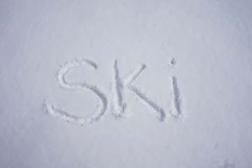Ski word written in a cold snow background