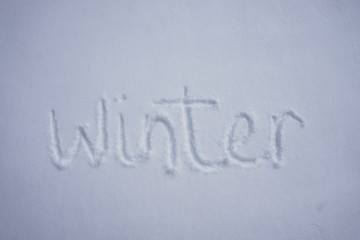 Winter word written in a cold snow background
