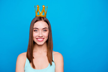 Close up photo beautiful amazing she her lady headwear head shiny glossy yellow gold crown showing presenting special status wear casual tank top outfit clothes isolated blue bright background © deagreez