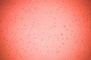 Rain droplets on red glass background, Water drops on glass.