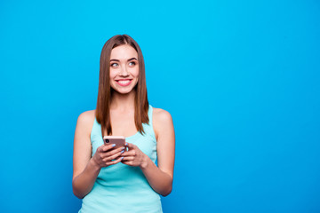 Close up photo beautiful amazing she her lady hold hands arms telephone smart phone look side empty space hear mom dad voices wear casual tank top outfit clothes isolated blue bright background