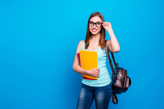 Close up photo funky beautiful amazing she her modern lady hold arms hands notebooks schoolgirl study applies pretty back bag wear specs casual jeans denim tank top clothes isolated blue background