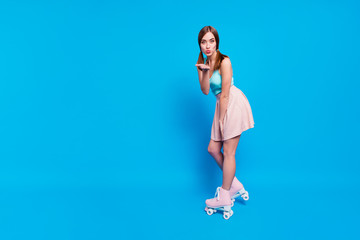 Full length side profile body size photo she her lady flirty send air kisses fit athletic legs retro rollers activity way life wear casual street summer pastel dress clothes isolated blue background