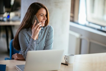 Girl at work, using her phone. Secretary answering calls. Manager at the office desk.