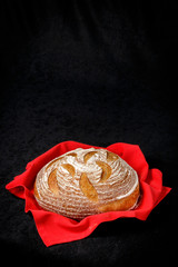 Handmade yeast-free bread on black background. Angle view with space for your text. 