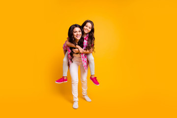 Full length body size photo of mom kid best fellows fellowship have free time feeling careless weekend holidays laughter fooling dressed in colorful trendy clothing isolated on vivid background