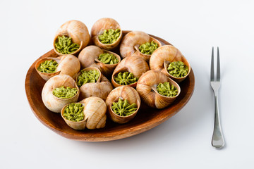 Fototapeta na wymiar Large Escargots de Bourgogne Snails baked on light background. Healthy food concept with copy space.