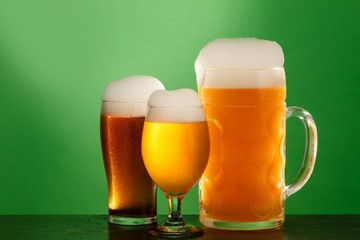 Golden beer in glass with foam, alcohol beverage,  lager froth.