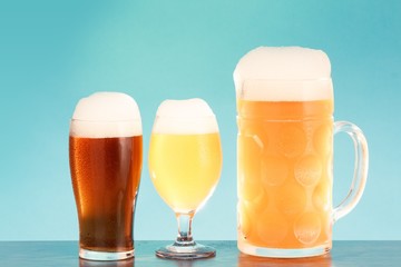 Golden beer in glass with foam, alcohol beverage,  lager closeup.