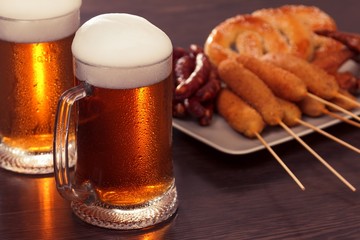 Beer glass alcohol drink with food sausage,  grilled picnic.