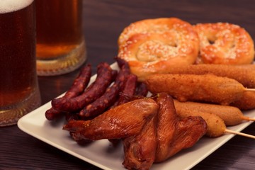 Beer glass alcohol drink with food sausage,  pub bar.