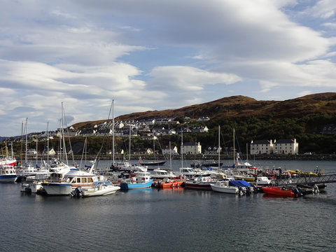 Bunte Boote im Hafen von Mallaig in Schottland bei sonnigem Wetter und blauem Himmel