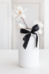 Upcycled jar with magnolia branch