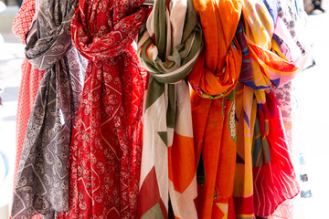 Scarves and cheiches hung in a store for sale in street market