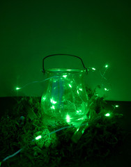 Magic cauldron on green background with moss and firefly and fog and smoke and bokeh