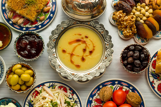 Traditional Turkish Ramadan,iftar meal table with lentil soup on the middle of table with other foods.Used Traditional Turkish Ceramic utensils and copper soup bowl together.