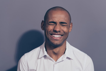 Obraz premium Close up photo funky amazing beautiful dark skin he him his macho perfect appearance giggle laughing out loud eyes closed listening humorous stories friends wear white shirt isolated grey background