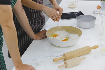 YOUNG COUPLE IN KITCHEN