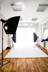 Empty photo studio with lighting equipment