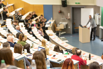 Fototapeta Conference and Presentation. Audience at the conference hall. Business and Entrepreneurship. Faculty lecture and workshop. Audience in the lecture hall. Academic education. Participants making notes. obraz